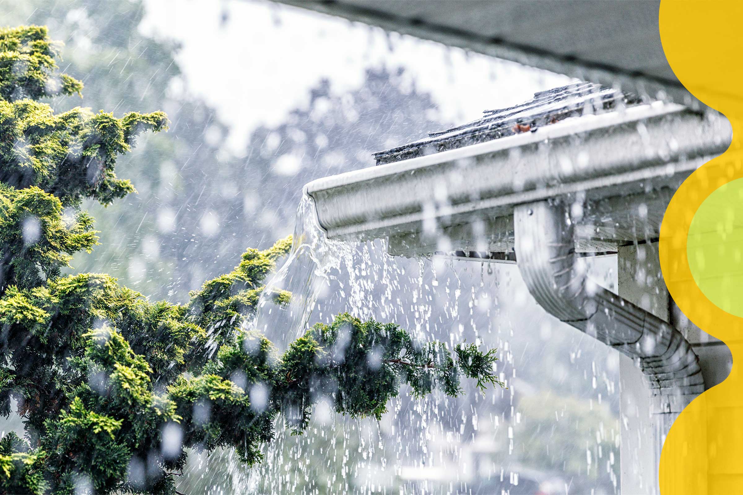 Torrential rains pour off of a roof, overflowing the rain gutter.