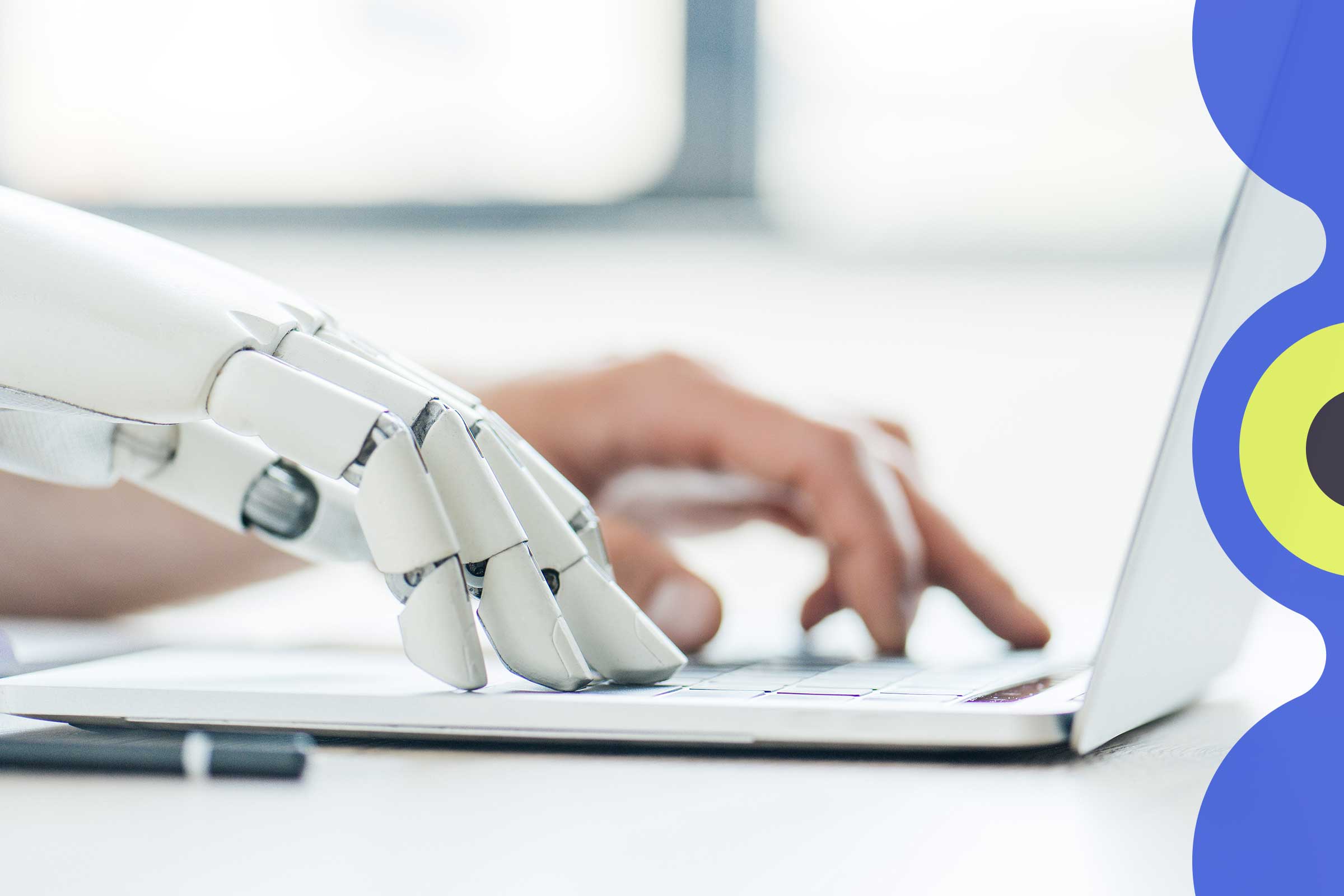 A human hand and a robot hand type side-by-side on a laptop keyboard.